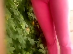 Filming brezss sexy of chick in pink yoga pants