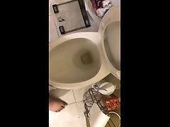 chubby guy pisses into toilet
