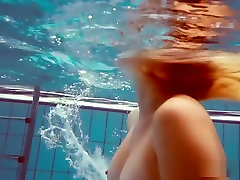 Cute redhead plays naked underwater