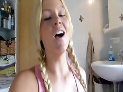 Woman with pigtails massages her cunt before a nice shag