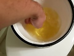 pissing full bladder into a bucket