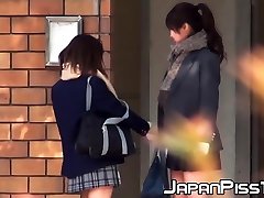 Japanese babe and her friend piss together out in public