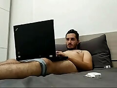 handsome bearded tattoed guy jerking on his bed