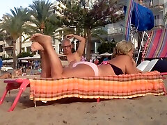 Grannys candid feet and soles rubbing at the beach - part. 2
