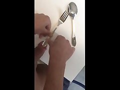 working my cockhead with a fork and spoon
