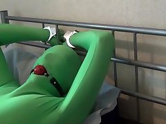 tied up and ball gagged in green spandex zentai bodysuit