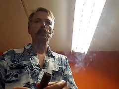 cigar smoking in gas mask