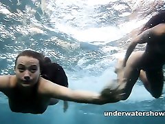 Julia and Masha are swimming nude in the sea