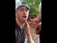 hot guy takes a cum shot into the mouth outside
