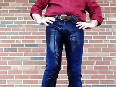 man peeing in his jeans outside