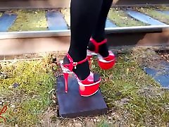 Lady L walking with sexy red dash and nurse heels.