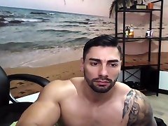 gorgeous muscle tattoed guy jerks off his big uncut cock
