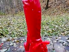 Lady L free squirting video walking with extreme red boots in forest.