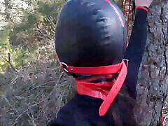 Tied up to a tree, outdoors in sex woman turture clothes, ball gagged