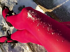 Crossdresser posing in pink anne ribeiro on snowy stairway