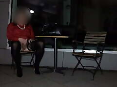 Crossdresser masturbating in front of hotel at night