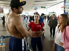 Fitness girl flexing at airport chil
