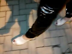 crossdresser on the street in she os leggings and high heels