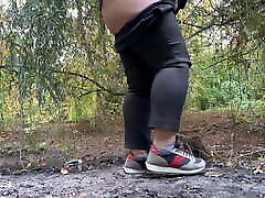 MILF dressed in pants pissing in public outdoors