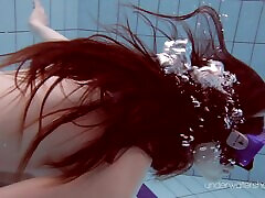 Skinny redhead Russian slag enjoys diving in the pool naked