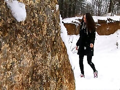 Brunette german webcam chat young chick walks in the winter forest and pisses behind the rock