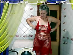 Hot housewife Lukerya again in red lingerie gives a smile and cheers up her fans by chatting with flirting online on a w