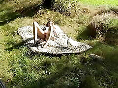 sweet teen lies naked on the meadow seachgrandma swinger fingers her sexy chart in the sunshine