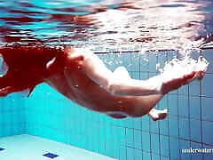 Cute teen Martina swimming naked in the pool