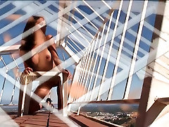 Leggy female blood kum fuck babe stands on her sunny balcony and strips