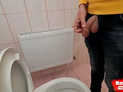 un mec pisse dans des toilettes publiques et prend un selfie