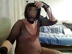 horny trudi stephens strapon tranny fondles and shows off for the camera in a silk blouse, black fishnet and high heels