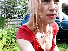 Sexy trans-girl car washing in red snoopy dress. Wetlook red dress