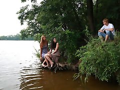 On the edge of the lake, this young stud has an experience that he`ll never forget. Both of these barely legal babes are horny and both need his cock right then and there.