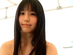 Svelte Japanese cutie runs around the beach in tiny yellow bathing suit