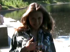 Fabulous lusty young babe shows off her big boobs and sexy ass by the lake