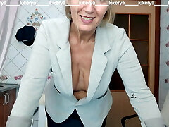 Lukerya attempts on a jacket to a skirt, displays naked boobs