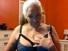 Grandma 68 years shows big milk cans and pussy