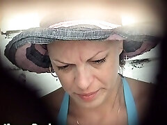 Mature milky nymph in blue bikini pisses in the public toilet room on the beach