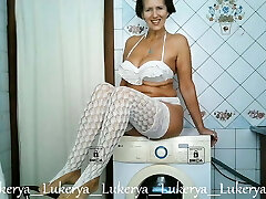 Lukerya teases with her assets at home in the kitchen
