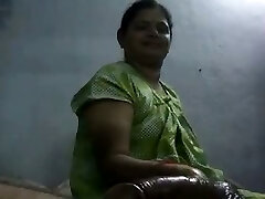 Mature and happy Indian aunty giving oily handjob on webcam