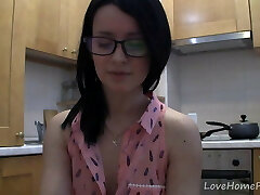 Splendid nubile with glasses chatting in the kitchen