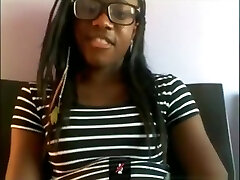 Dark-hued bore with glasses masturbates with a hairbrush on her bed on skype