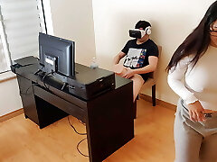 Hot stepmother strokes next to her stepson while he watches pornography with virtual reality glasses
