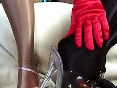 Sensual teasing close up legs and feet in Shiny glistening pantyhose and high heels.