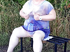 Stepmom in the park undressing and masturbating on a bench