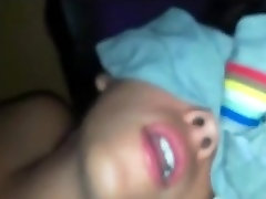 Shy girl hides her face, while she plays with a vibrator