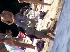 Marvelous chicks with pretty boobs taking sunbaths on the beach