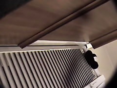 Man with cam trying to see something in change room
