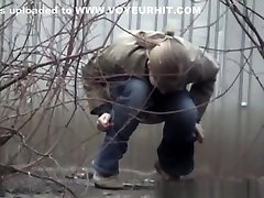 Woman pees beyond shelter