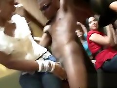 Horny stripper is getting his cock sucked by several chicks
